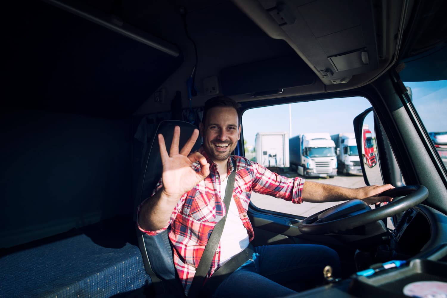 truck driver sat in his cabin chair ok gesture
